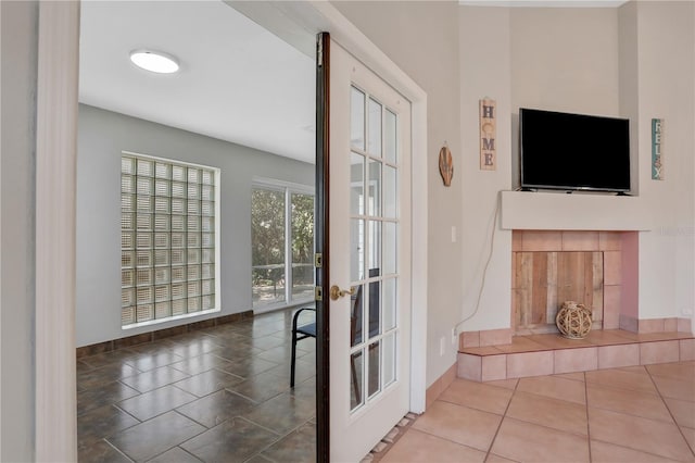 44 Capistrano Dr, Ormond Beach, FL 32176 - doorway to outside featuring french doors, a fireplace, baseboards, and tile patterned floors