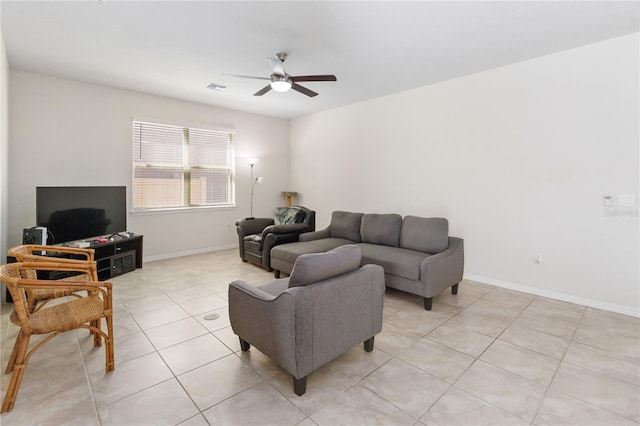 living room with light tile patterned floors, ceiling fan, visible vents, and baseboards