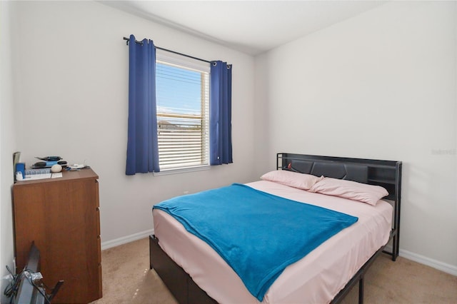 bedroom featuring carpet floors and baseboards