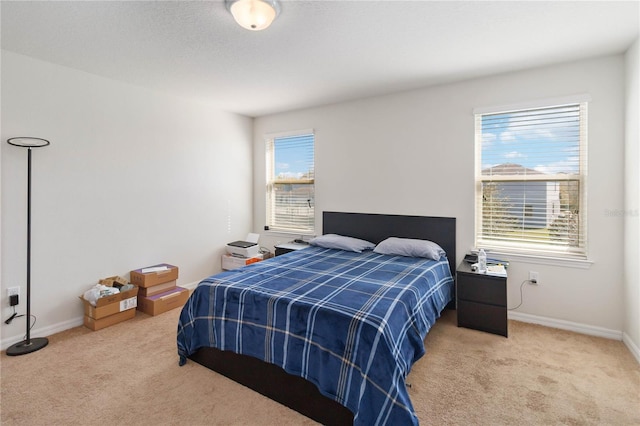 carpeted bedroom with baseboards