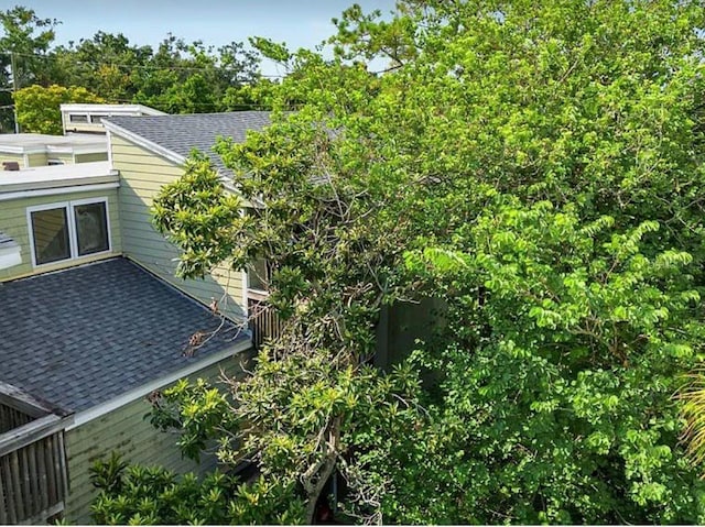 exterior space featuring a shingled roof