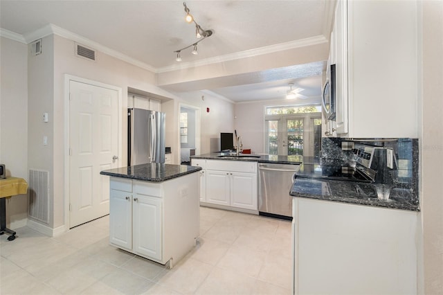 kitchen with white cabinetry, visible vents, appliances with stainless steel finishes, and crown molding