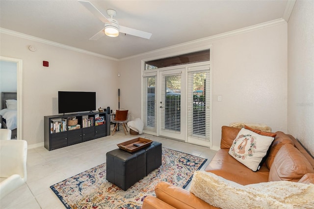 living area with baseboards, ornamental molding, a ceiling fan, and tile patterned floors