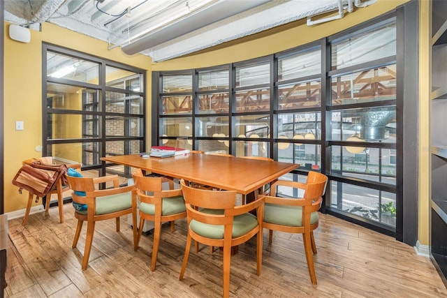 dining space featuring wood finished floors and baseboards