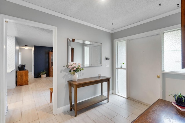 foyer entrance with ornamental molding, a healthy amount of sunlight, and a textured ceiling