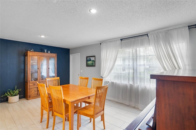 dining space with a textured ceiling