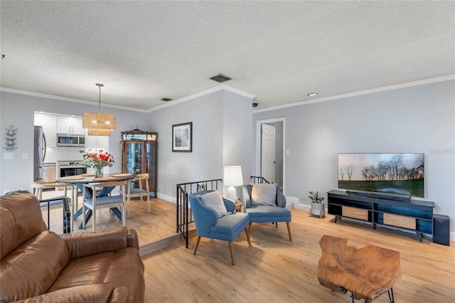 living room with light wood-type flooring, visible vents, and baseboards