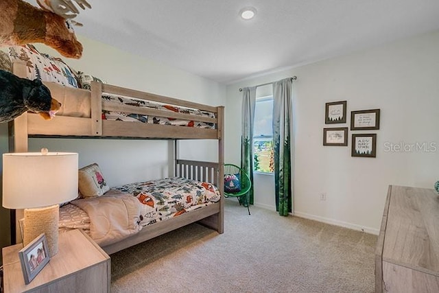 bedroom with carpet floors and baseboards