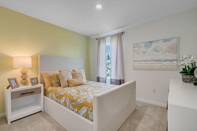 carpeted bedroom featuring baseboards