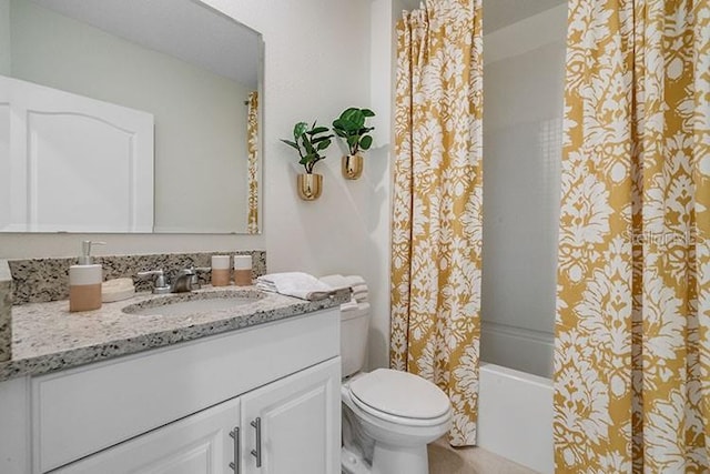 full bathroom featuring toilet, shower / bath combination with curtain, and vanity