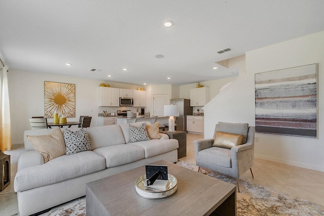 living area featuring recessed lighting, visible vents, baseboards, and light tile patterned flooring