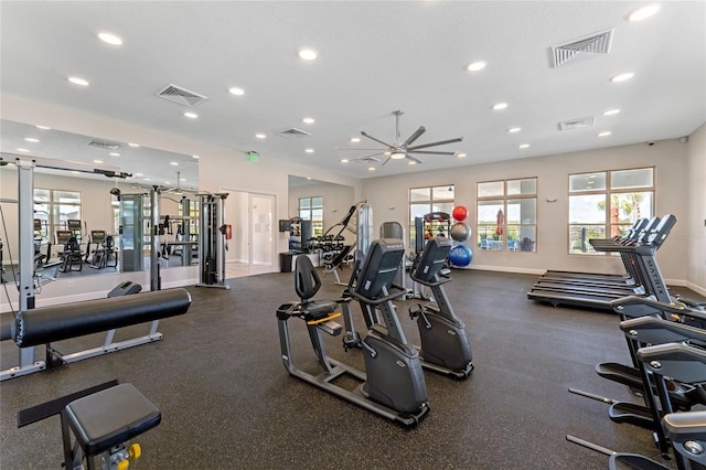 exercise room with baseboards and visible vents