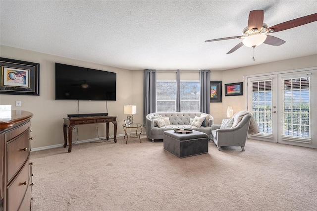 living room with a textured ceiling, baseboards, french doors, and light colored carpet