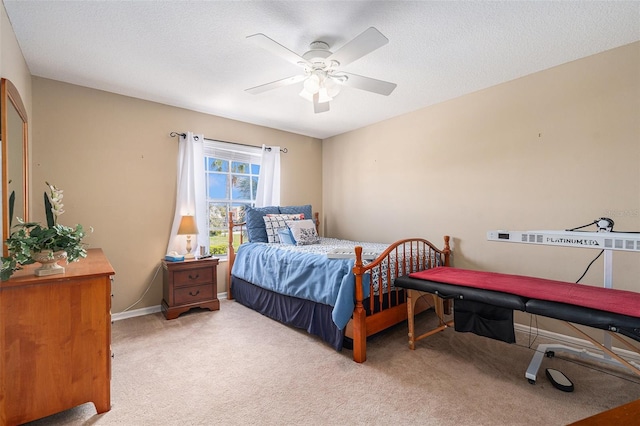 bedroom with carpet, ceiling fan, a textured ceiling, and baseboards