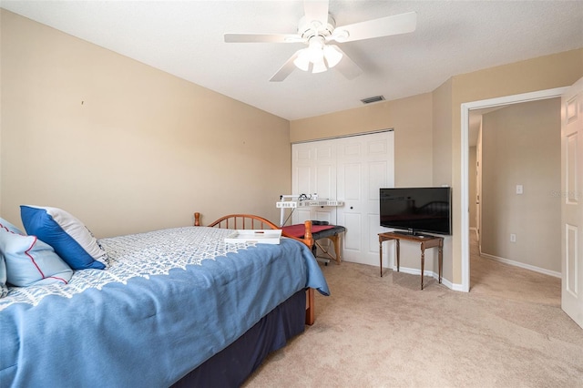 bedroom with light carpet, a ceiling fan, visible vents, baseboards, and a closet