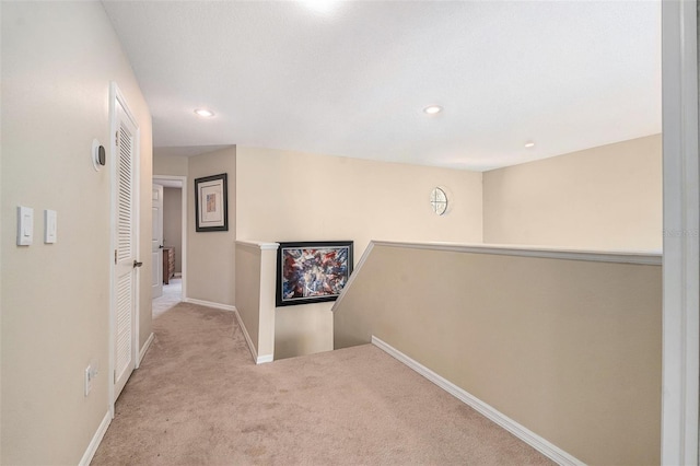 corridor featuring recessed lighting, carpet, an upstairs landing, and baseboards