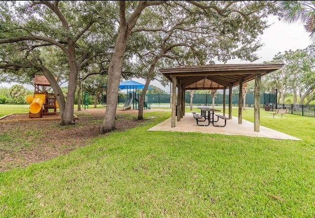 view of home's community featuring playground community, a lawn, a gazebo, and fence