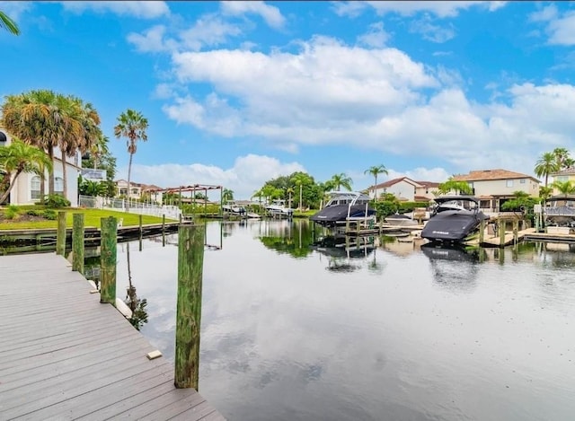 view of dock with a water view and a residential view