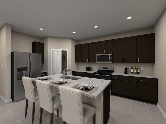 kitchen with appliances with stainless steel finishes, a kitchen bar, a sink, and recessed lighting