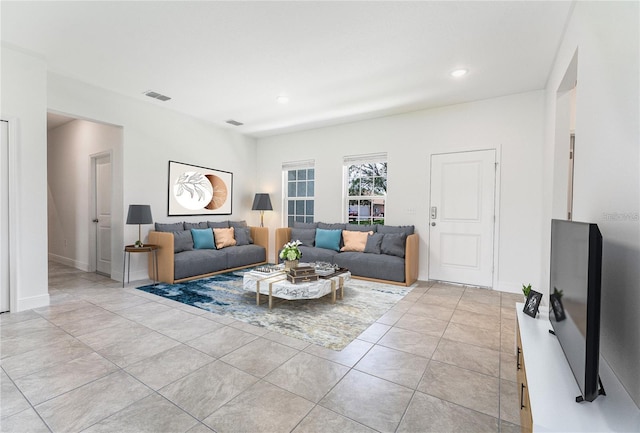 living room with recessed lighting, visible vents, baseboards, and light tile patterned floors