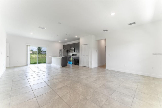 unfurnished living room with baseboards, visible vents, and recessed lighting