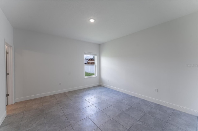 tiled empty room with baseboards