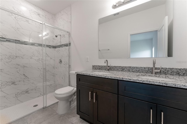 full bath featuring toilet, a marble finish shower, visible vents, and a sink