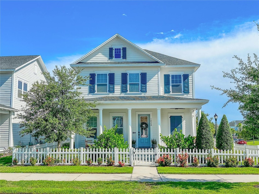 view of front of property with a porch and a fenced front yard