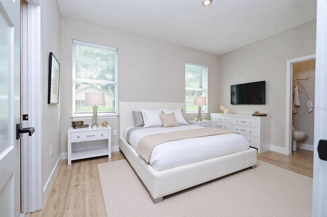 bedroom featuring light wood-style flooring and baseboards