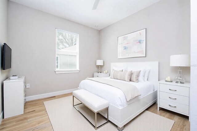 bedroom featuring baseboards, a ceiling fan, and light wood-style floors