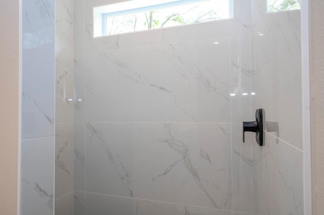 full bathroom with a marble finish shower