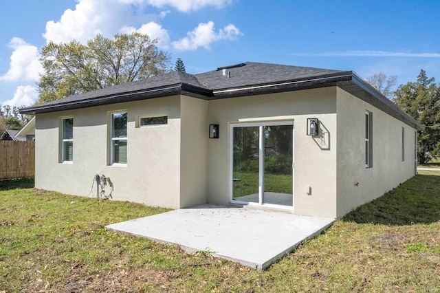 back of house featuring a patio area, fence, stucco siding, and a yard