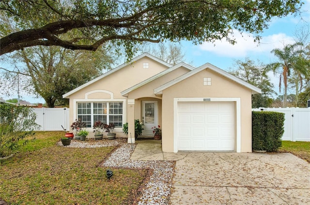 ranch-style house with a garage, a gate, and stucco siding