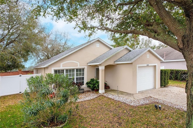 ranch-style house featuring stucco siding, a shingled roof, fence, a garage, and driveway