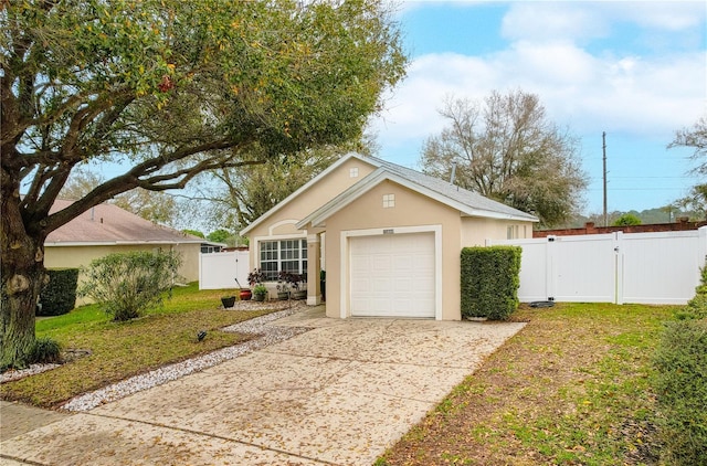 view of front of property with a garage, fence, concrete driveway, a gate, and stucco siding