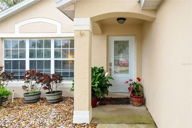 doorway to property with stucco siding