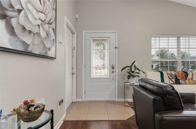 entrance foyer with light wood-style floors and baseboards