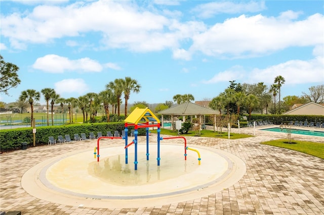 communal playground with a water play area, a community pool, and fence