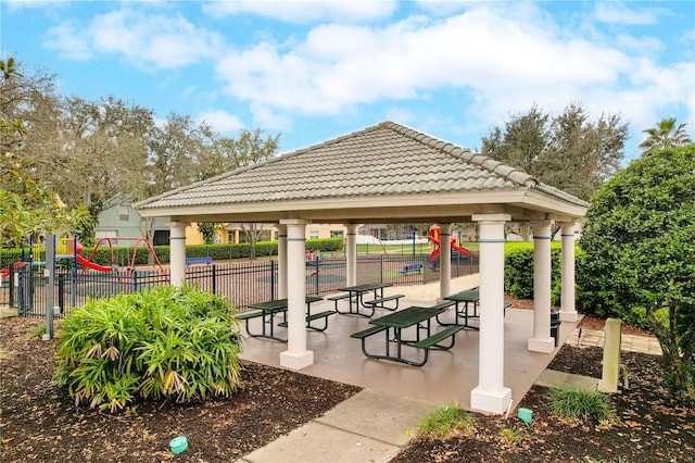 view of home's community with a gazebo, playground community, and fence