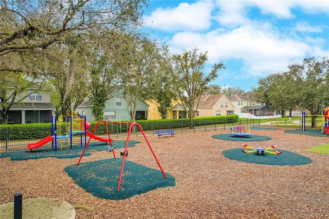 communal playground featuring a residential view and fence