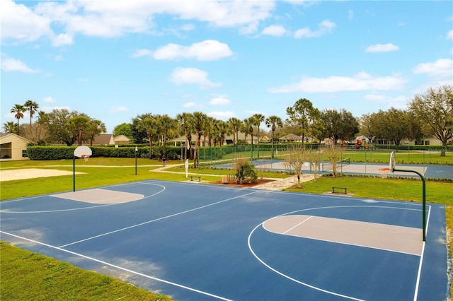 view of sport court featuring community basketball court and a lawn