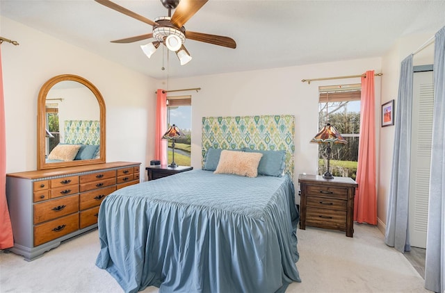 bedroom featuring a ceiling fan and light colored carpet