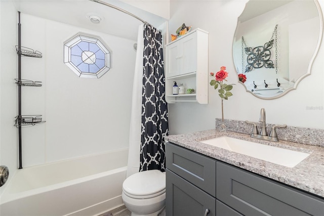 full bathroom with shower / tub combo with curtain, vanity, and toilet