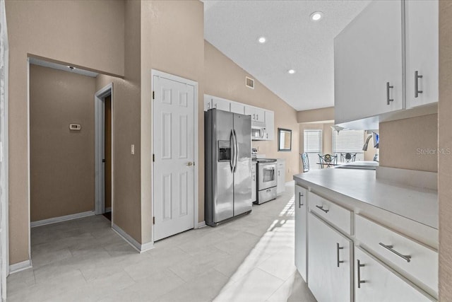 kitchen with light countertops, recessed lighting, stainless steel appliances, white cabinetry, and a sink