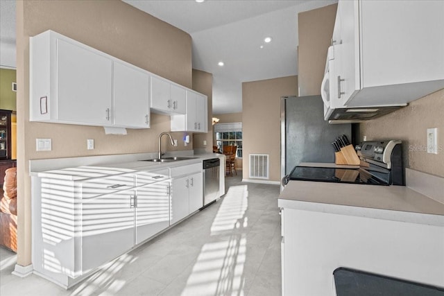 kitchen with visible vents, a sink, white cabinetry, appliances with stainless steel finishes, and light countertops