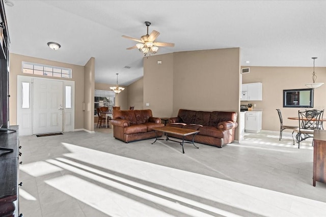 living area with visible vents, baseboards, and lofted ceiling