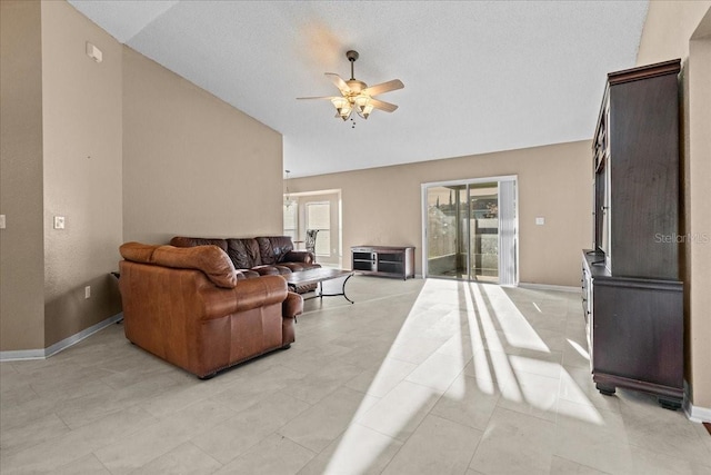 living area featuring lofted ceiling, a ceiling fan, and baseboards