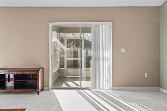 doorway featuring baseboards