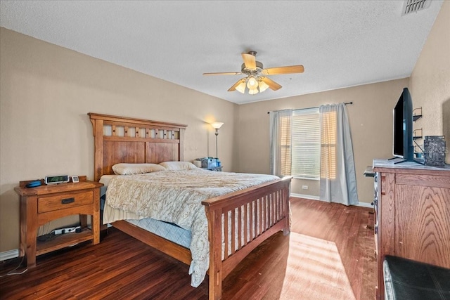 bedroom with visible vents, ceiling fan, baseboards, and wood finished floors