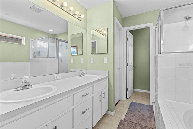 full bath with a sink, tiled tub, a stall shower, and tile patterned floors